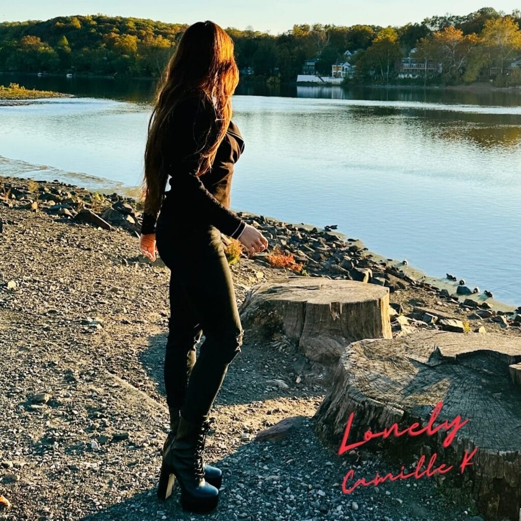 Camille K Teams Up with M11SON for Bright and Infectious New Pop Single Titled “Lonely" 35 Official single cover artwork for "Lonely" featuring M11SON which shows Camille K in a black outfit standing by a lake at sunset, casting long shadows. Surrounding trees have autumn hues. Text reads "Lonely Camille K" in red.