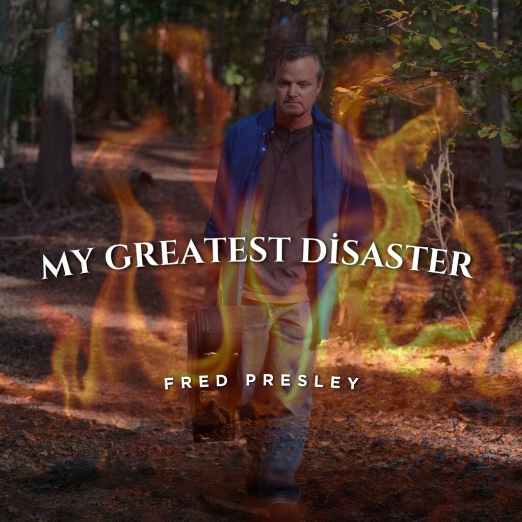 Official single cover artwork for "My Greatest Disaster" which shows Fred Presley walking through a forest wearing a grey t-shirt under an open blue shirt and jeans. A flame filter has been applied making it look like he's walking through flames. The title text and the artist's name is displayed in white text in the middle and two-thirds down.